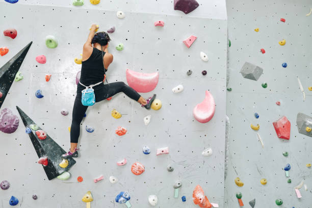 istock Fit Athlete Climbing up Bouldering Wall 1327059760