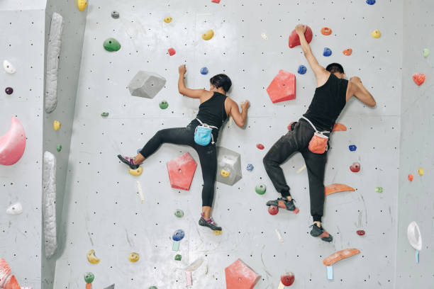 istock Couple Climbing up the Bouldering Wall 1327059775