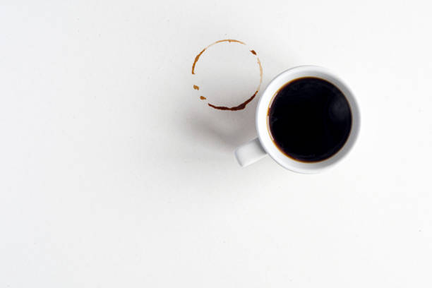 istock Coffee mockup. White ceramic mug with espresso or americano hot coffee on blank dirty surface, table. 1327060864