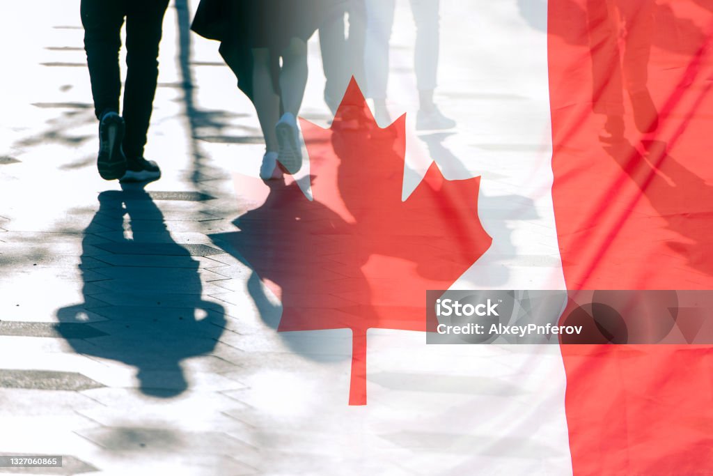 The National Flag of Canada and shadows of people, concept picture Canada Stock Photo