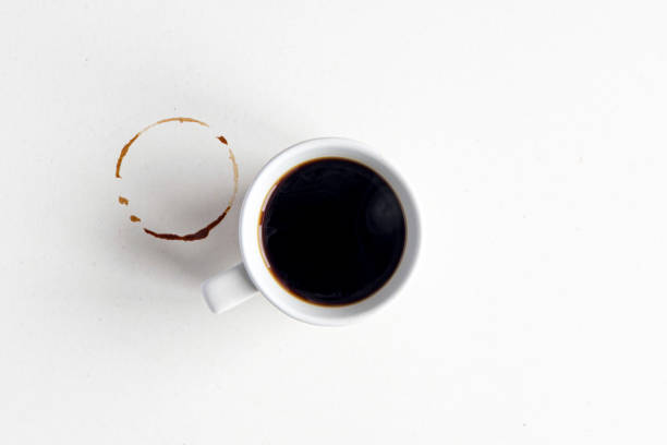 istock Coffee mockup. White ceramic mug with espresso or americano hot coffee on blank dirty surface, table. 1327060877
