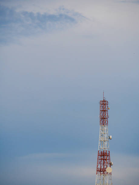 istock A radio telecommunication antenna with blue sky background and clouds. 1327062336
