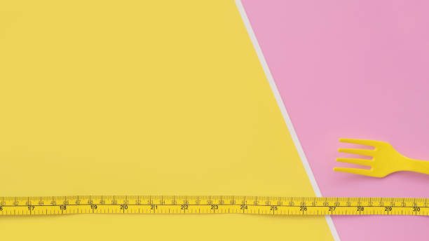 istock close up of plastic fork and tape measure 1327064814