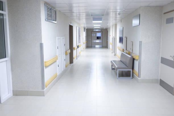 istock Empty modern hospital corridor with sitting couch 1327065035