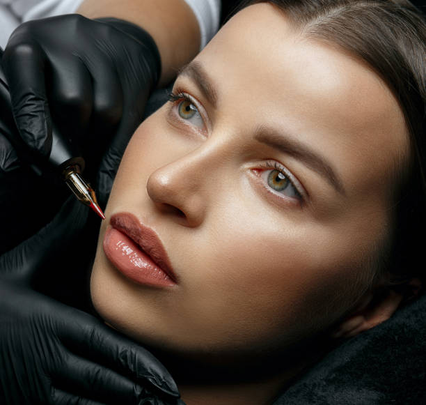 istock Wonderful brunette woman having lip permanent makeup 1327065219