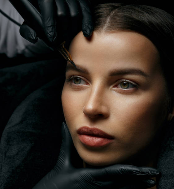 istock Attractive brunette woman having eyebrow tattoo procedure 1327065222