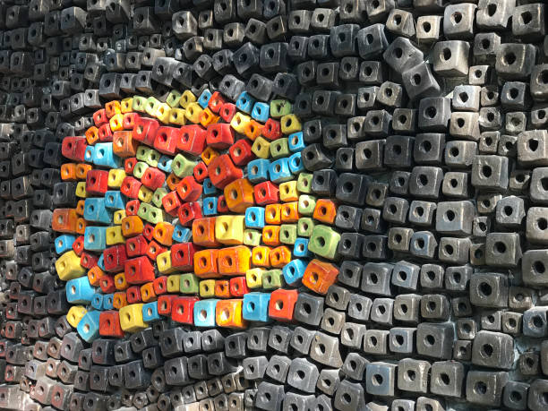 The wall is covered with brightly colored cube-shaped ceramic mosaics.