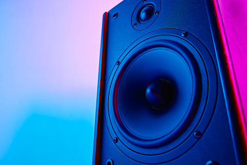 Stereo speaker on purple colored background. Sound audio loud speaker with copy space