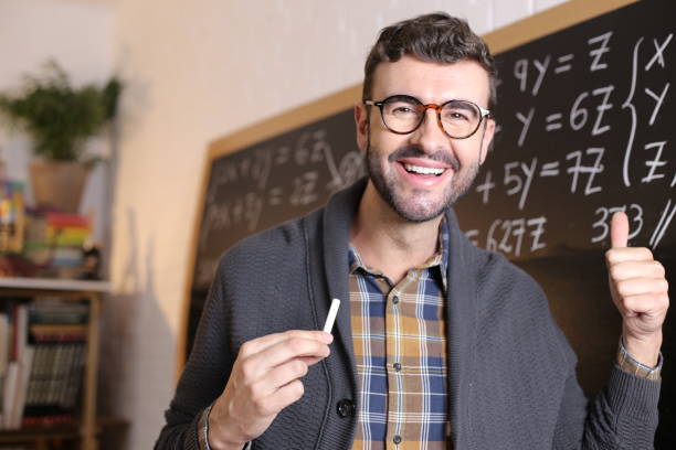 istock Teacher giving a thumbs up in classroom 1327068301