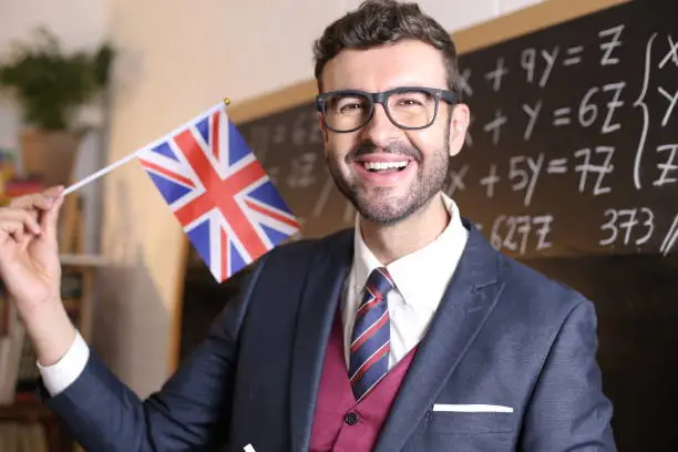 Photo of Elegant teacher holding the British flag