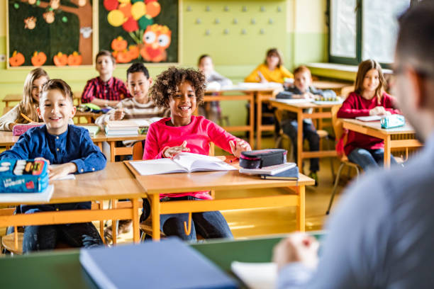 istock Large group of happy students attending a class at elementary school. 1327072275