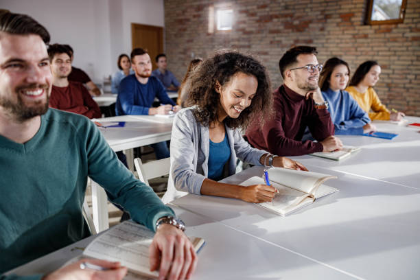 istock Large group of happy students attending a class in the classroom. 1327073672