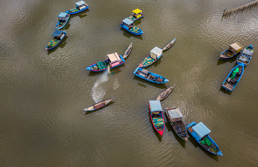 Drone view of Fishing boats are nailing by the fish farm on the Nha Trang river, Nha Trang city, Khanh hoa province, central Vietnam