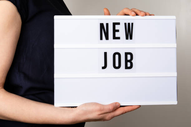 istock New Job concept. Woman holding a light box with text 1327074635