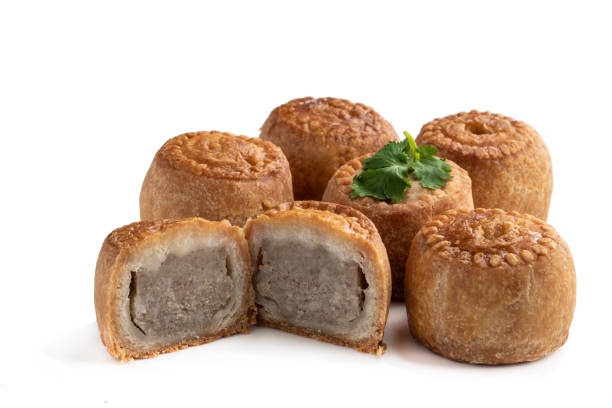 istock Mini Melton Mowbray pork pies with one halved isolated on white background 1327075154