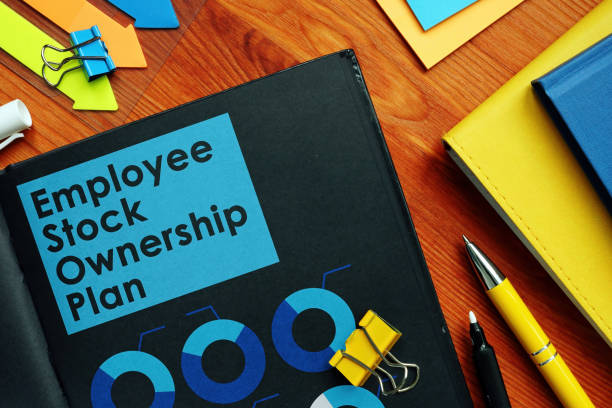 Employee Stock Ownership Plan ESOP and charts on the pages. Employee Stock Ownership Plan ESOP and charts on the black pages. stock certificate stock pictures, royalty-free photos & images