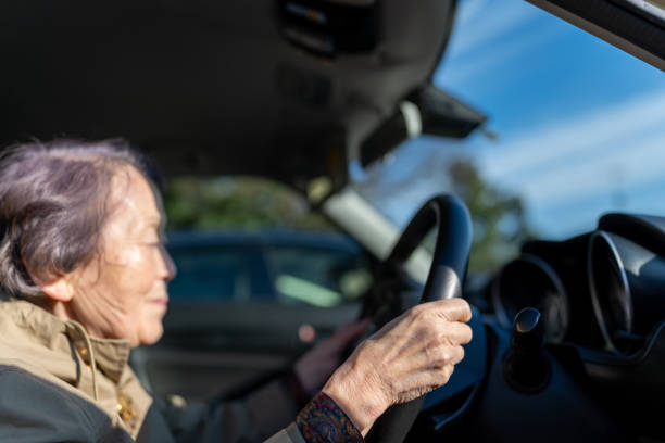 istock Asian senior woman driving a car 1327077521
