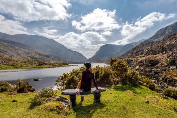 istock Female cyclist admiring mountainous scenery 1327078546