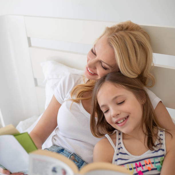 istock Mother and Daughter reading a book 1327078592