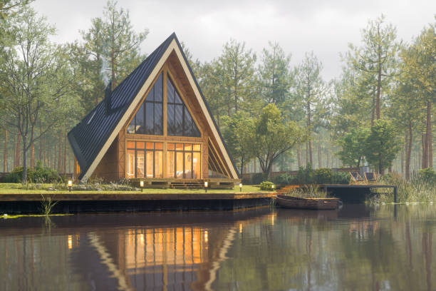 Triangular Modern Lake House At Fall Triangular modern lake house in a misty forest at fall. log cabin stock pictures, royalty-free photos & images
