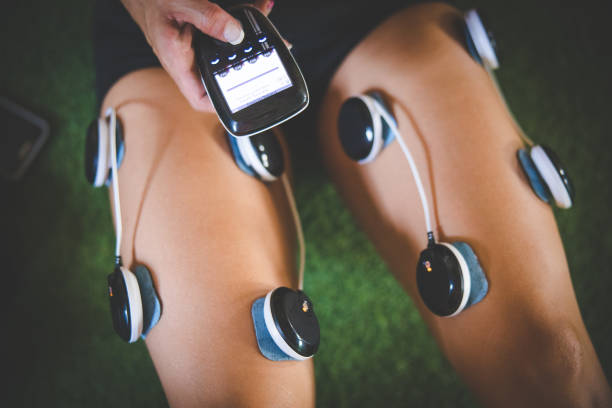 istock Female fitness model using electronic muscle stimulation technology after a hard training session. 1327080300