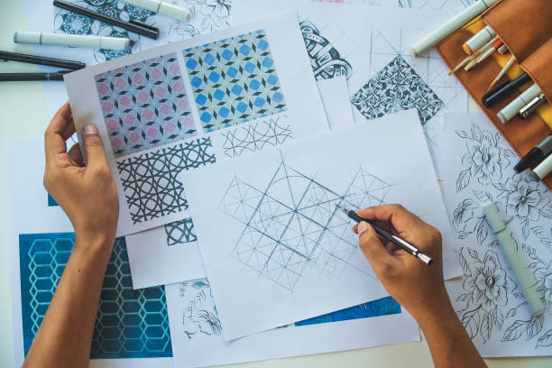 istock Designer designing drawing sketch pattern geometric flower seamless wallpaper fabric textile fashion industry. artistic design studio. 1327083383