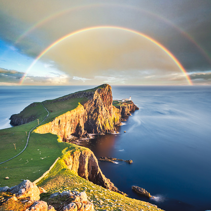 Wonderful sunset with rainbow at the Neist point lighthouse in Scotland
