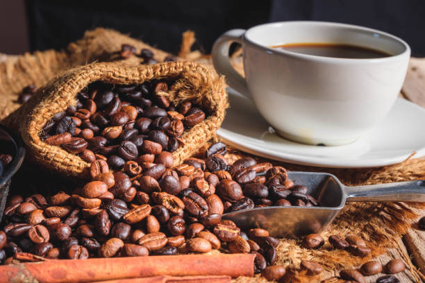 istock Coffee cup and beans on old woodden table 1327092310