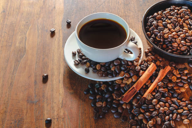 istock Coffee cup and beans on old woodden table 1327092312