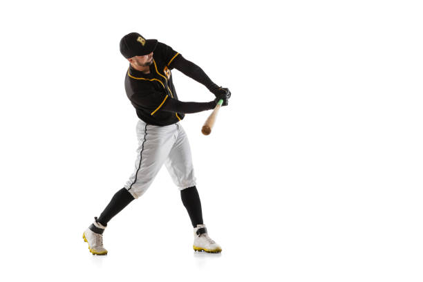 istock Baseball player, pitcher in a black white sports uniform practicing isolated on a white studio background. 1327093325