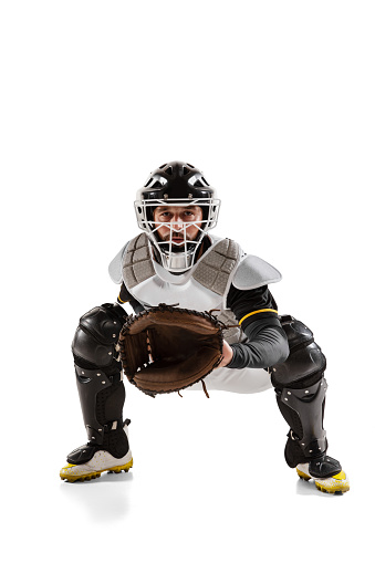 Position of catcher. One baseball player in white sports uniform practicing isolated on a white background. Young professional sportsman in action. Competition, show, movement and team sport concept.