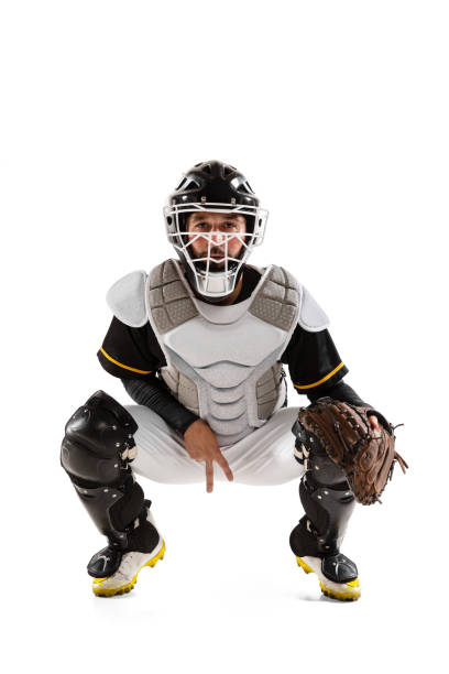 istock Baseball player, catcher in white sports uniform and equipment practicing isolated on a white studio background. 1327093352