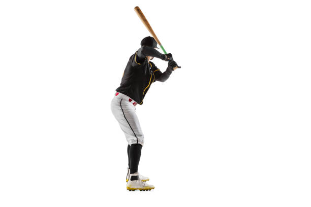 istock Baseball player, pitcher in a black white sports uniform practicing isolated on a white studio background. 1327093362