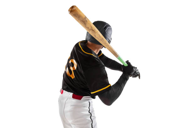 istock Baseball player, pitcher in a black white sports uniform practicing isolated on a white studio background. Back view 1327093367
