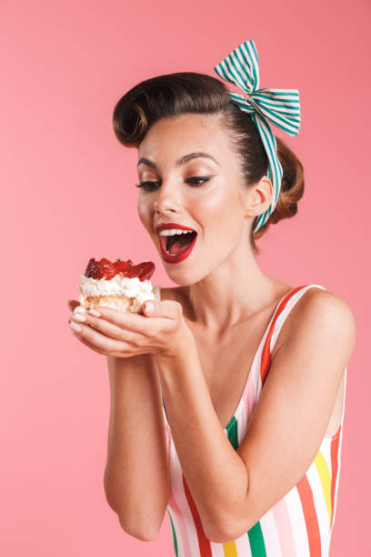 istock Beautiful pin up woman isolated holding cake. 1327093549