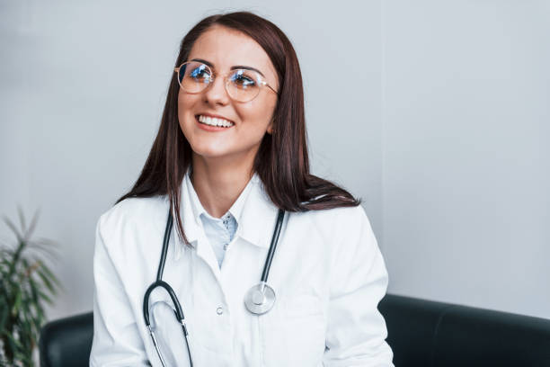 istock Friendly young nurse indoors in modern clinic ready to help you 1327093601