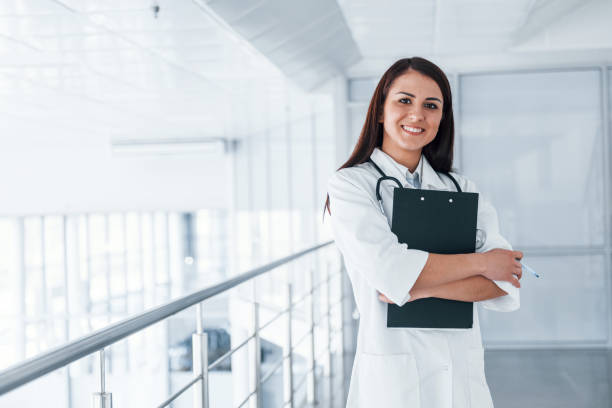 istock Friendly young nurse indoors in modern clinic ready to help you 1327093830