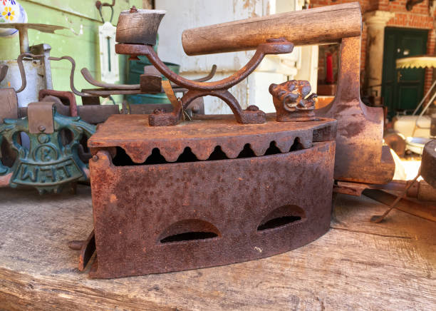 istock Ancient iron cast iron for ironing which is heated coals on vintage background 1327096654