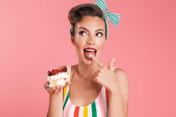 istock Beautiful pin up woman isolated holding cake. 1327096921