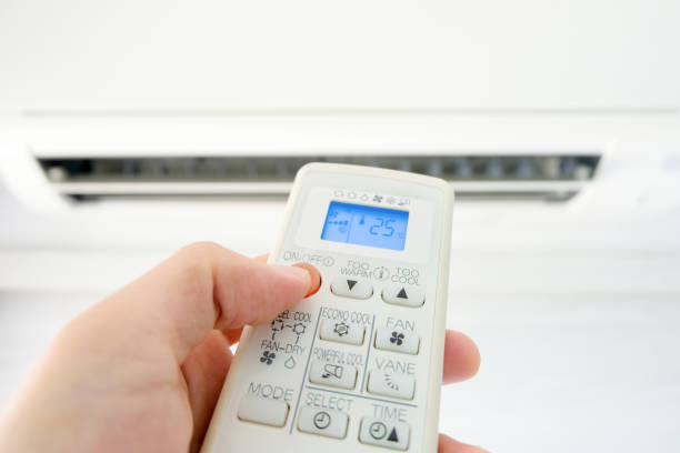 istock Man's hand using remote control open The air conditioner is cooled to 25 degrees Celsius in his bedroom. Health concepts and energy savings 1327097453