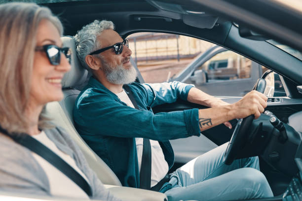 istock Happy senior couple enjoying car ride 1327097647
