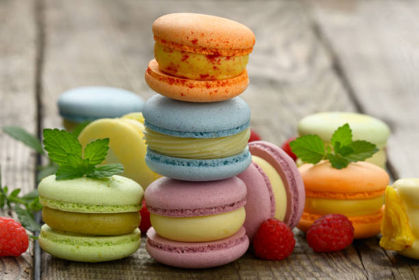 istock stack of baked multicolored macarons and different flavors on a gray wooden table 1327098290