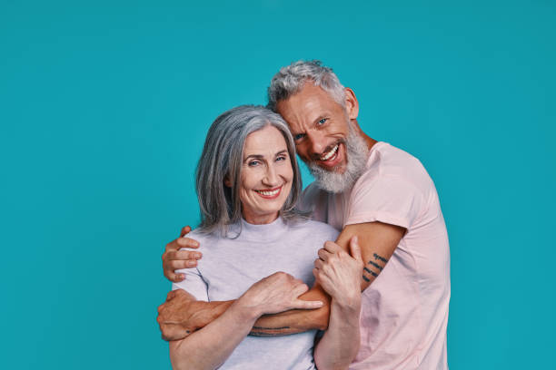 istock Romantic senior couple looking at camera and smiling 1327098291