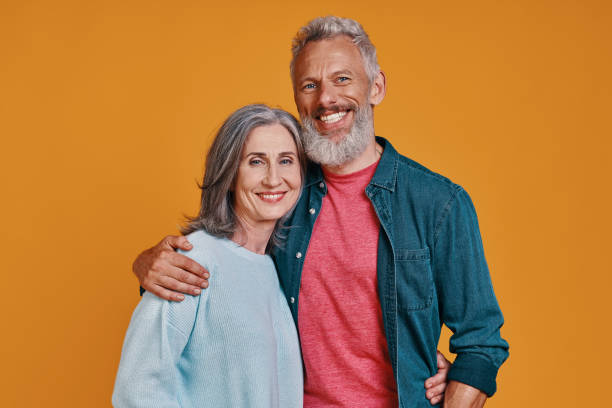 istock Romantic senior couple looking at camera and smiling 1327098399
