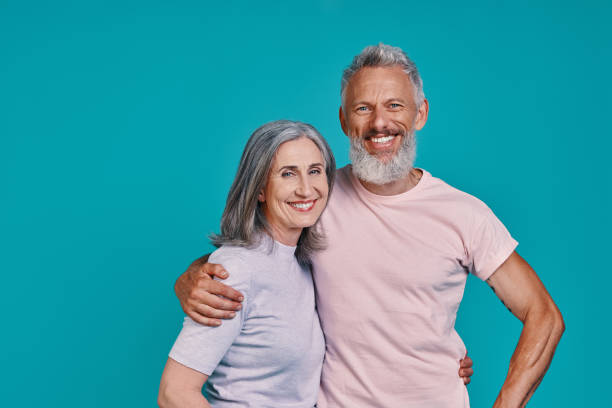 istock Happy senior couple looking at camera and smiling 1327098405