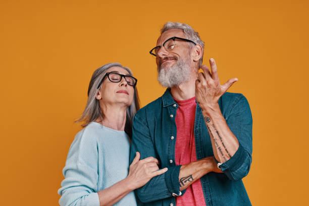 istock Playful senior couple in eyeglasses smiling and gesturing 1327098571