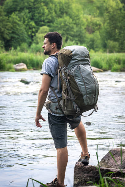 istock A hiker with a large hiking backpack on a hike. 1327100584
