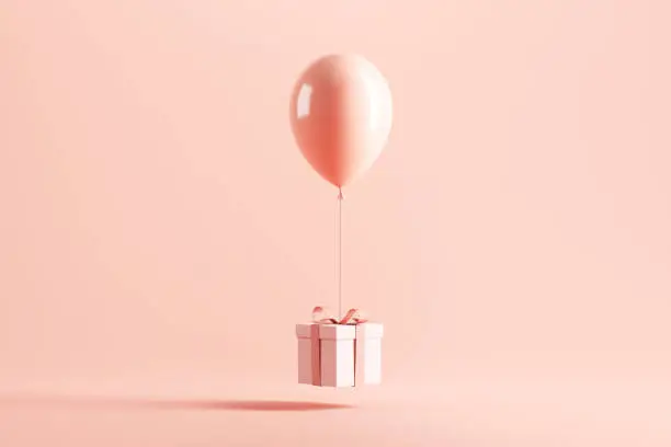 Photo of White gift box or present box with balloon on pink pastel color background