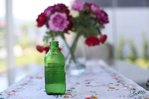 Sparkling water on the table with pink flowers
