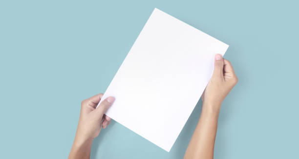 istock Hands holding paper blank for  letter paper 1327105567